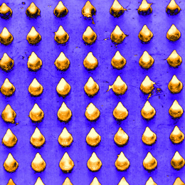 grid of rounded gold cones on an indigo background